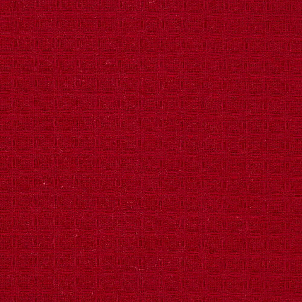 A close-up of a deep red textured fabric with a subtle woven geometric pattern.