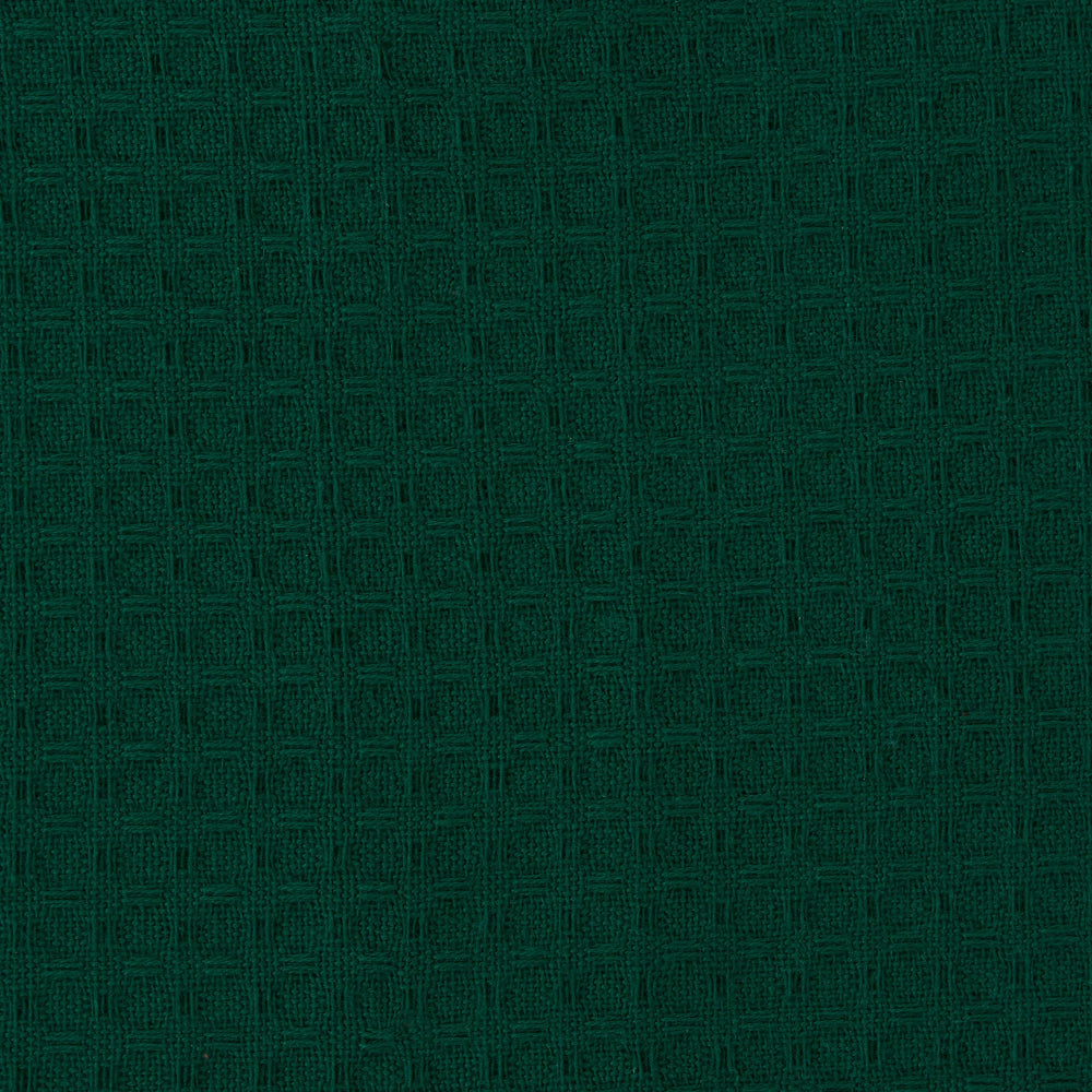 A close-up of dark green textured fabric with a subtle woven geometric pattern.