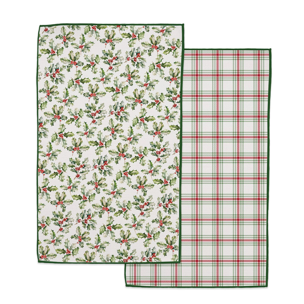 Two Christmas-themed kitchen towels shown on a white background. One towel features a green holly and berry pattern on an off-white background, and the other features a green and red plaid pattern.