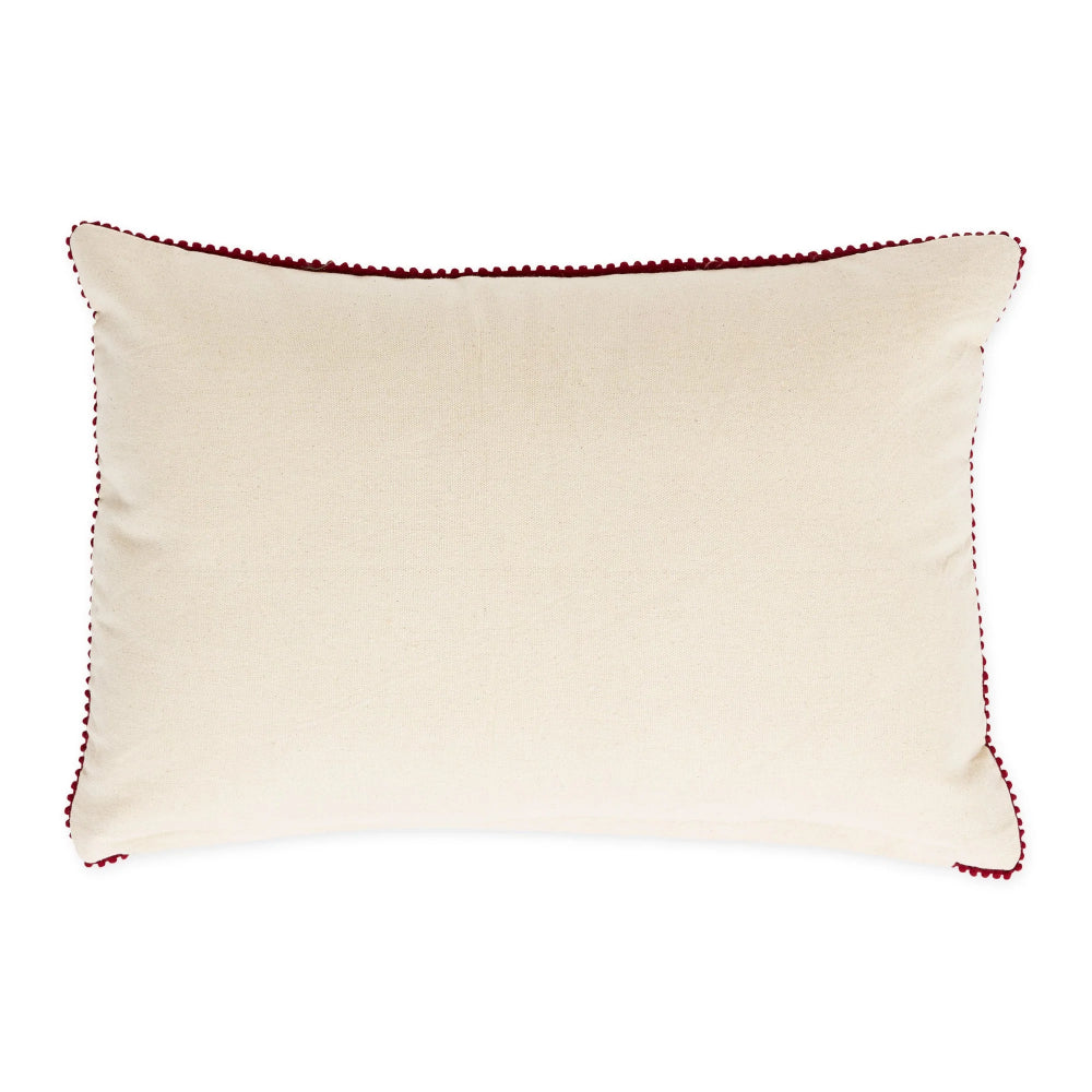 An off-white rectangular throw pillow with dark red pom-pom trim along the edges, shown against a plain white background.