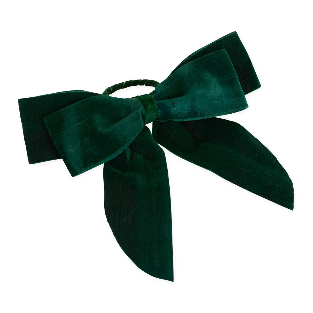 A dark green velvet hair bow with long ribbon tails, attached to a matching dark green elastic band, shown on a plain white background.