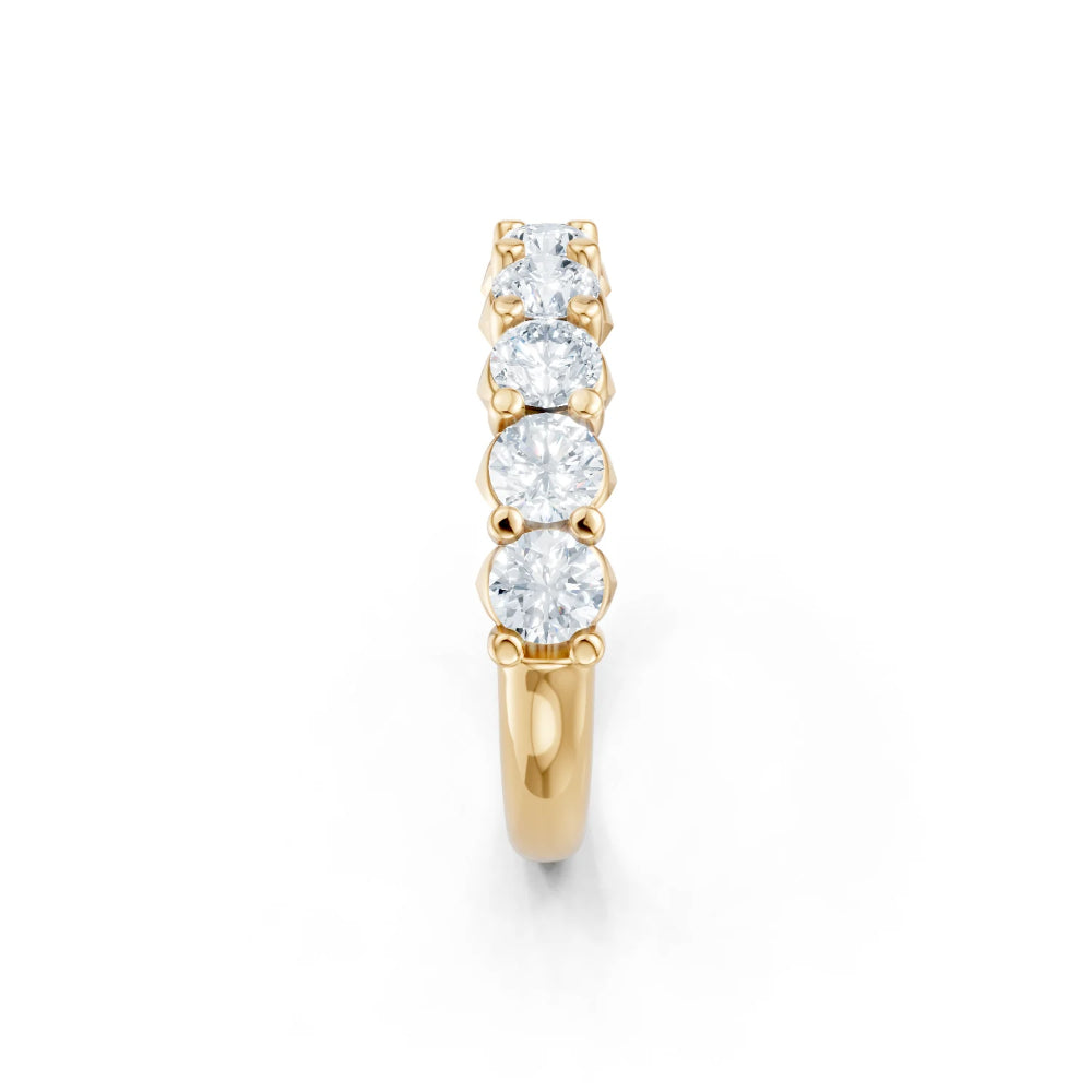 Gold ring with round diamonds on a white background