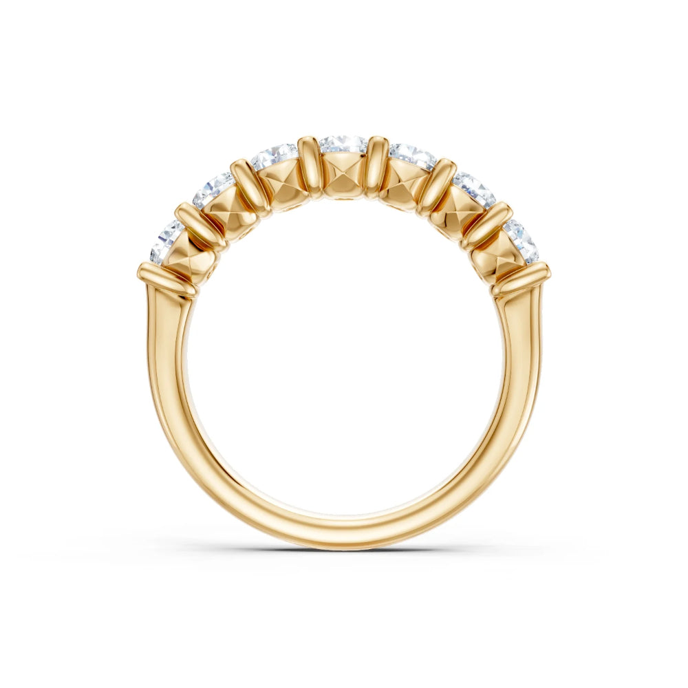 Gold ring with diamond accents on a white background