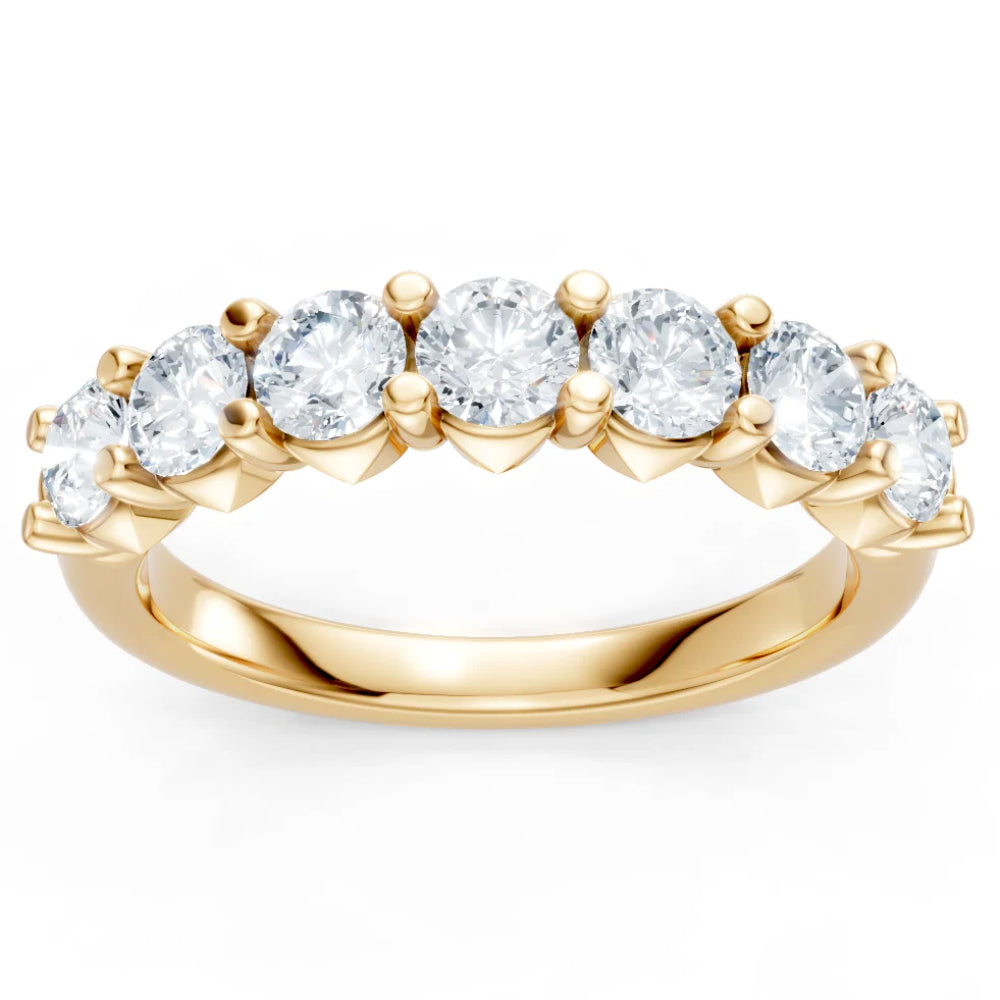 Gold ring with clear gemstones on a white background