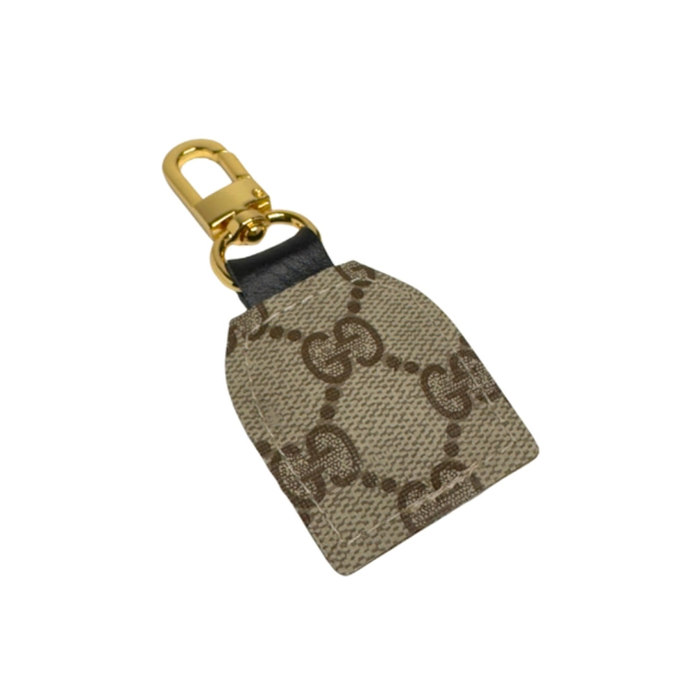 Gucci keychain with gold clasp on a white background