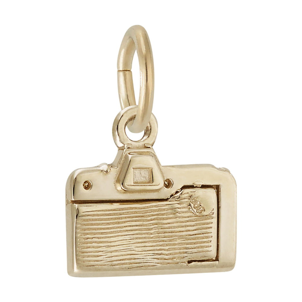 A polished gold charm shaped like a vintage camera, featuring a textured lens, shown on a plain white background.
