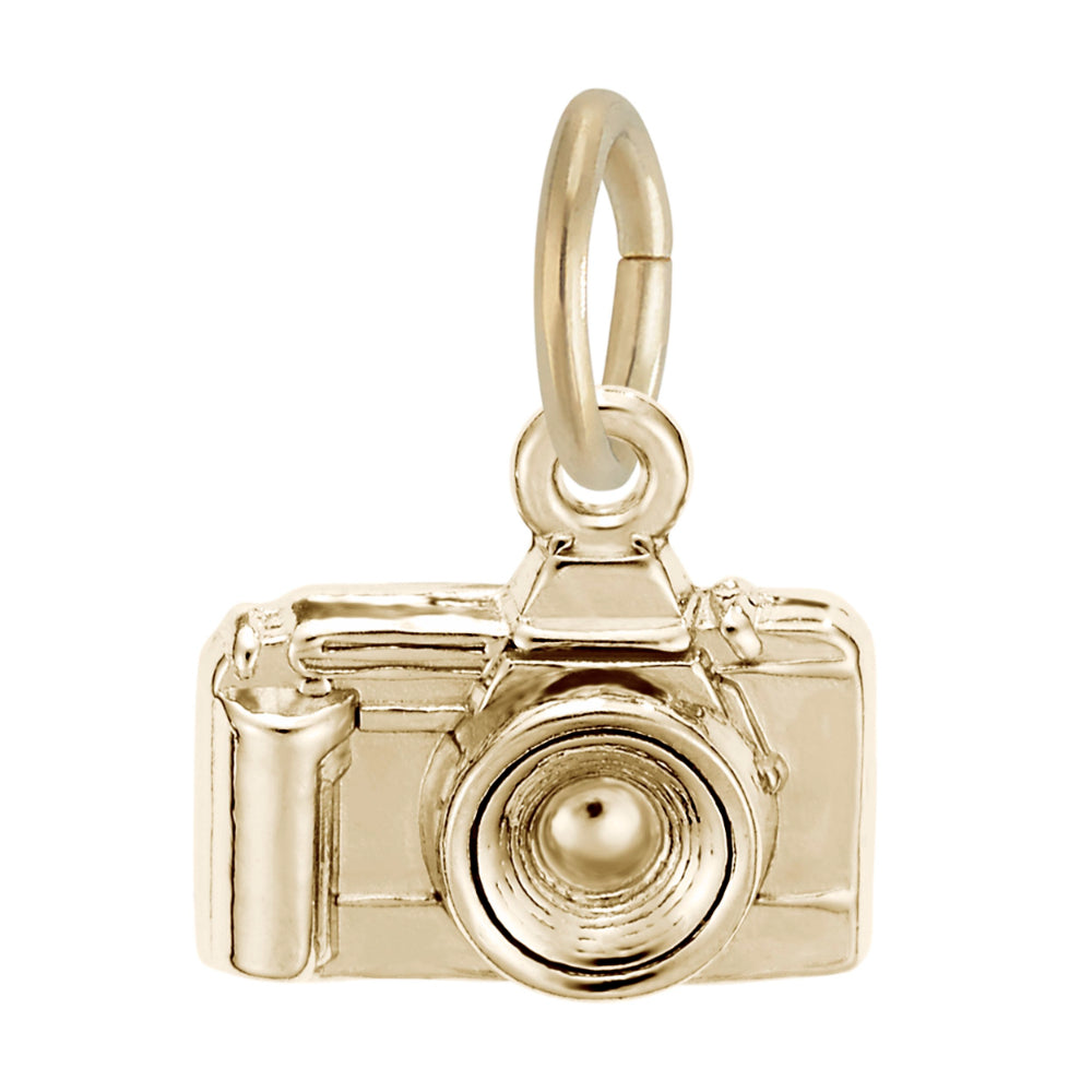 A polished gold charm shaped like a vintage camera, featuring a textured lens, shown on a plain white background.