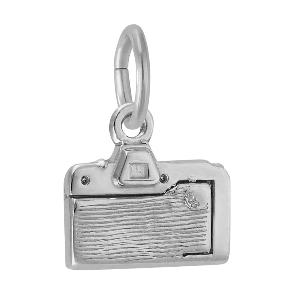 A silver charm shaped like a vintage camera, featuring a textured lens, shown on a plain white background.