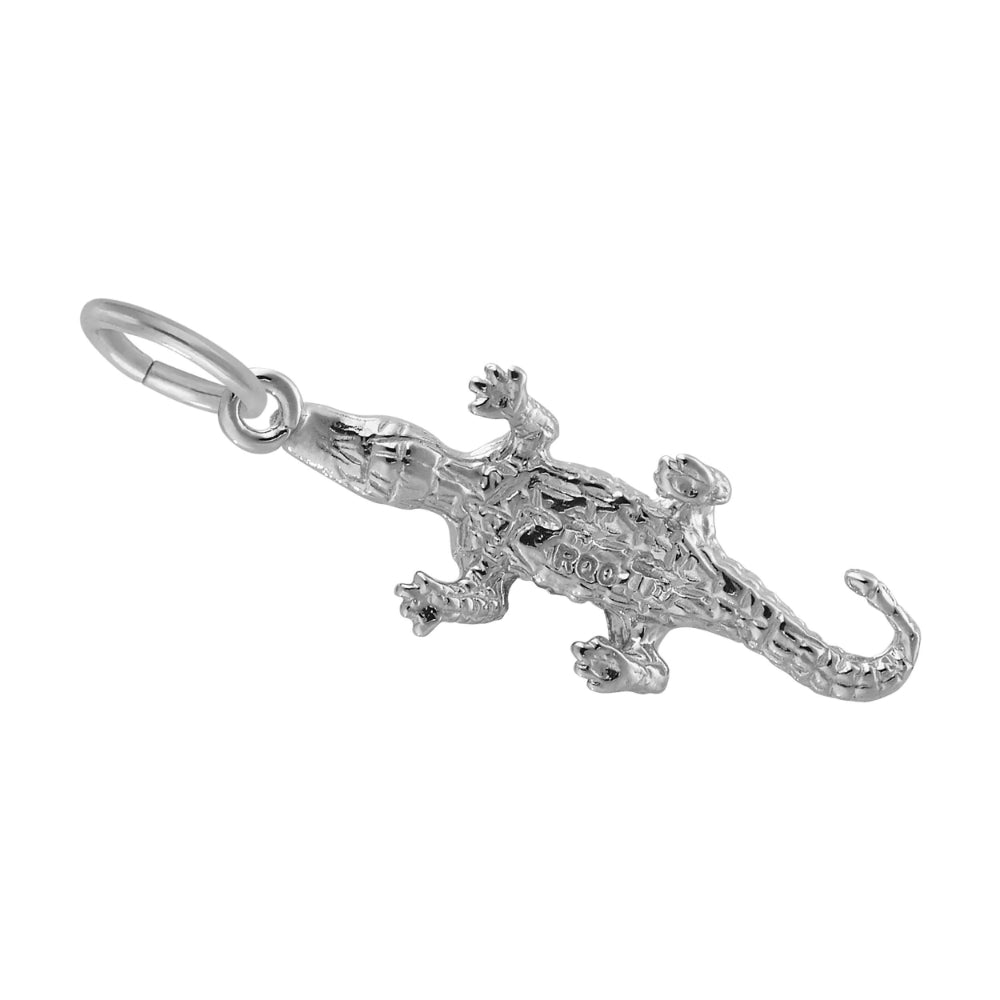 Bottom of a silver alligator charm showing RQC logo and hollow center, shown on a white background