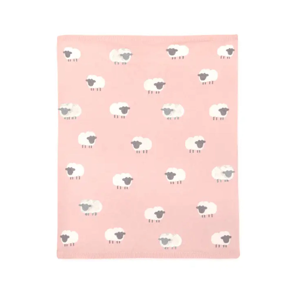 Pink blanket with white sheep pattern on a white background.