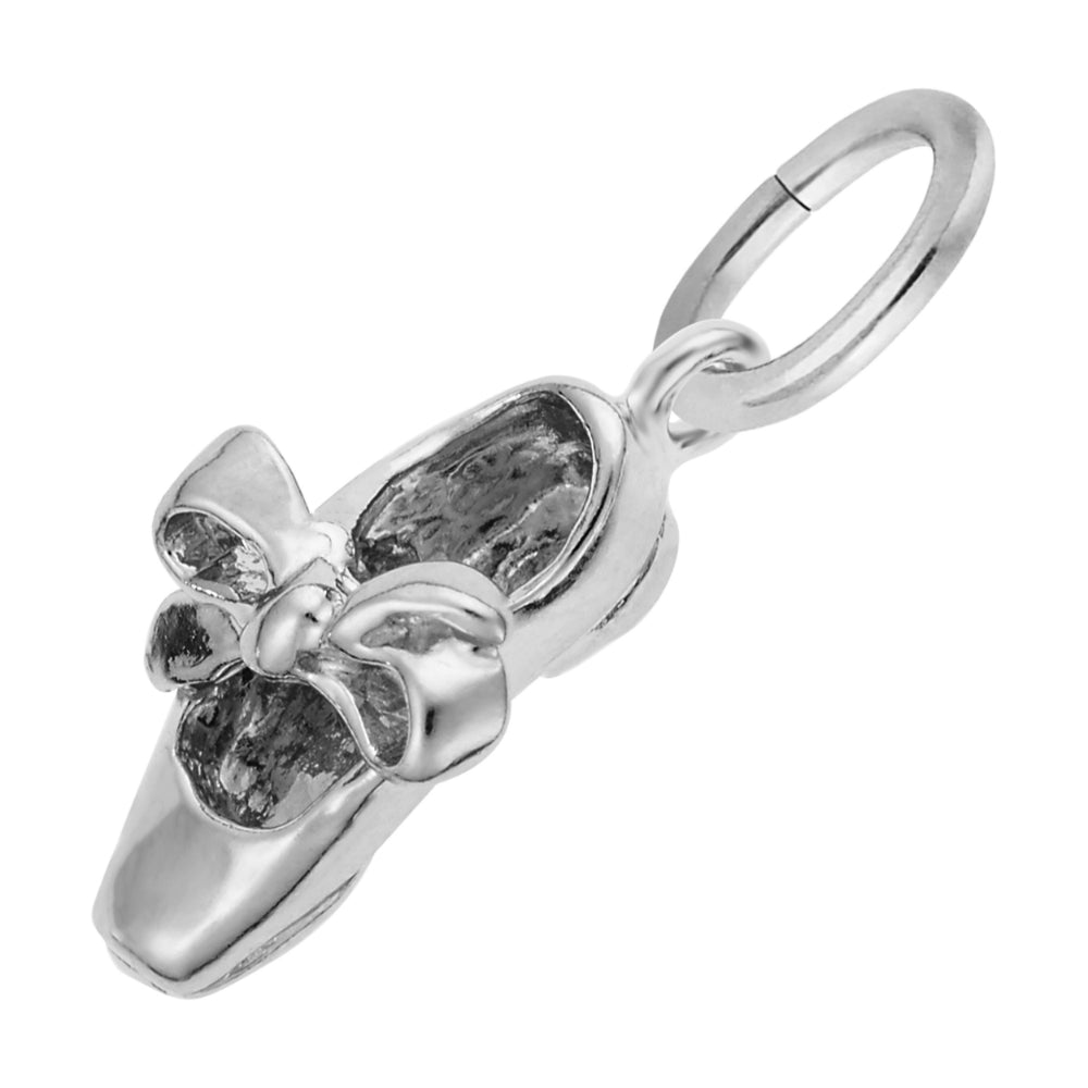 A polished silver charm shaped like a tap shoe with a bow detail, shown on a plain white background.