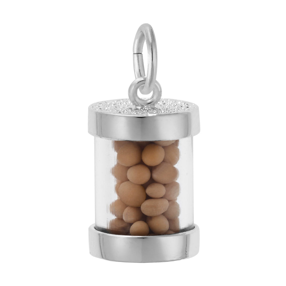A silver cylindrical charm filled with small mustard seeds, featuring a textured top and bottom rim, shown on a plain white background 