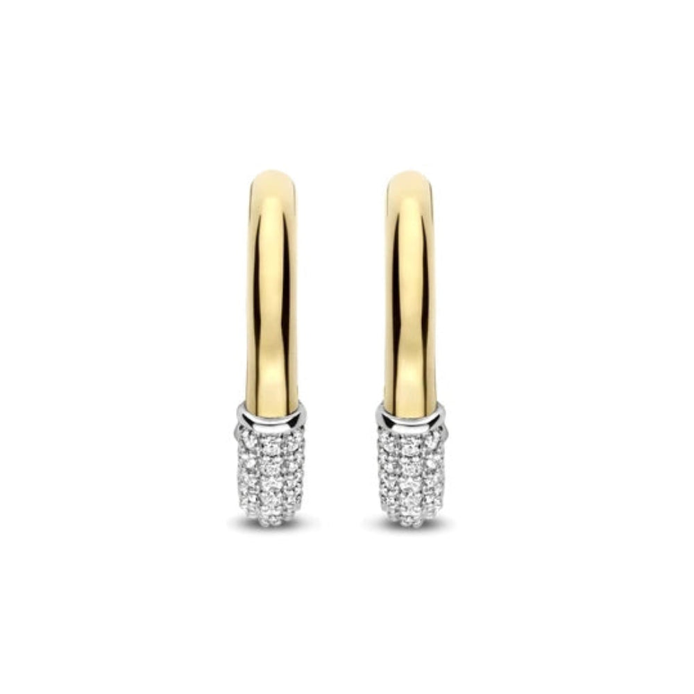 A pair of gold hoop earrings with pavé-set clear stones at the bottom, shown on a plain white background.