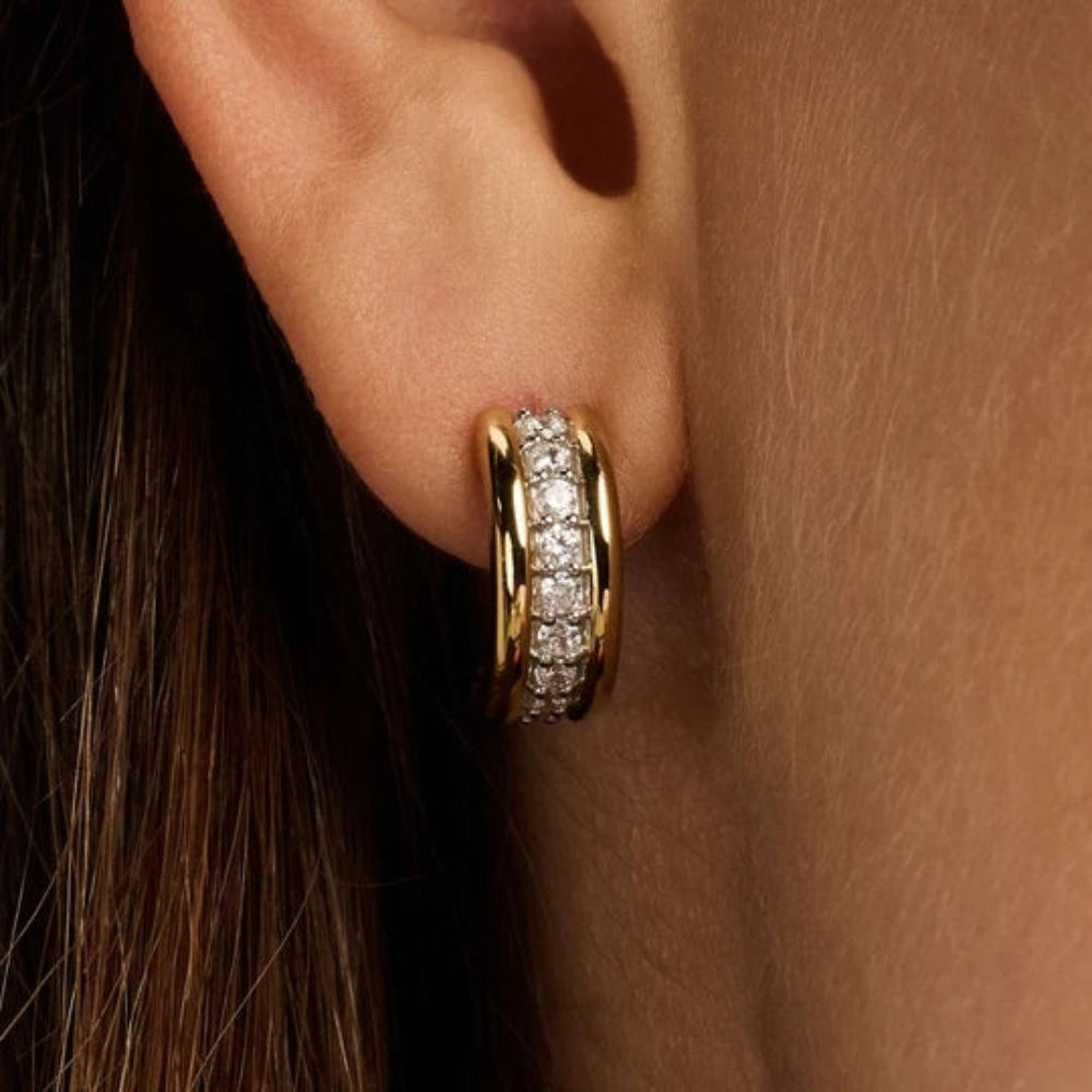 woman wearing gold toned center strip cubic zirconia stones 