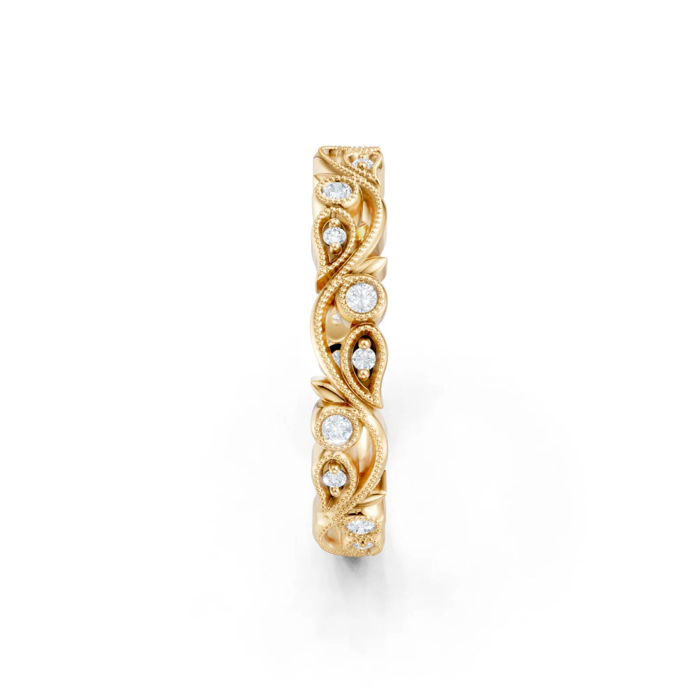 Gold ring with intricate design and embedded diamonds on a white background