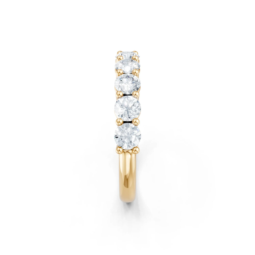 Gold ring with three diamonds on a white background