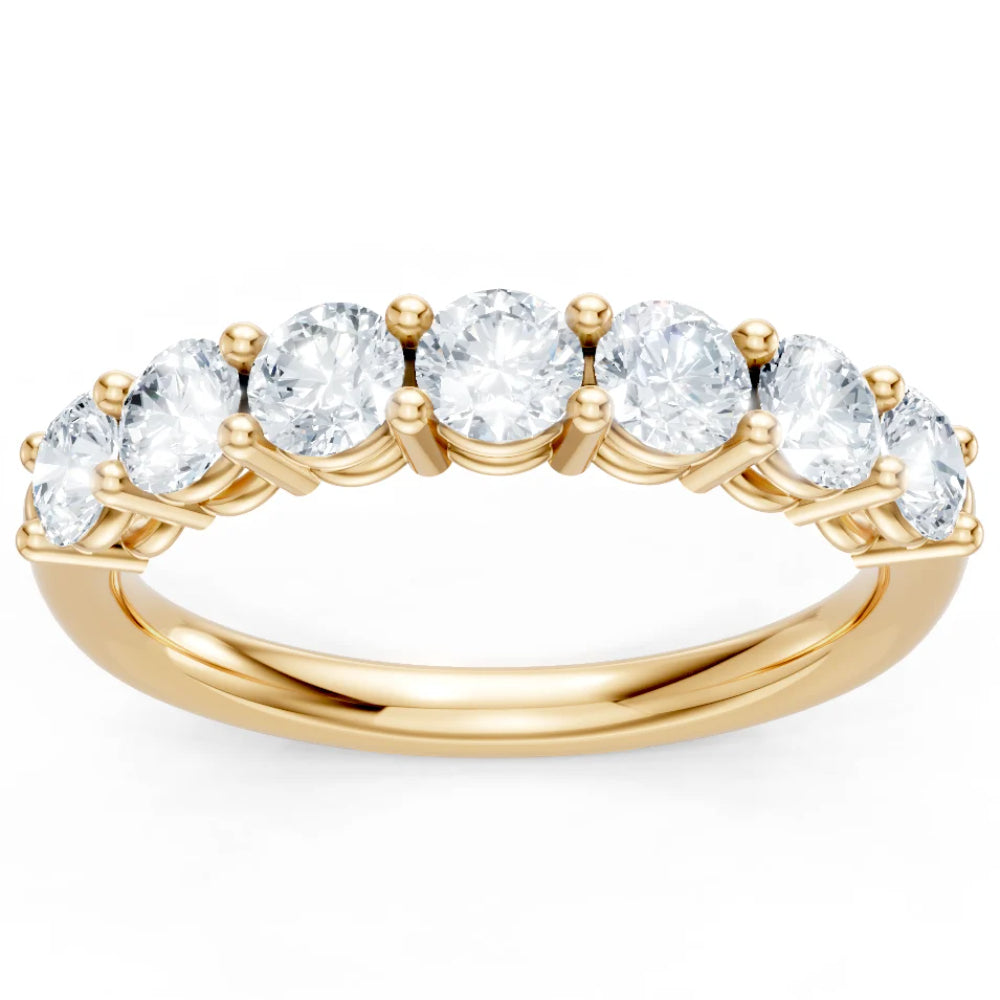 Gold ring with clear gemstones on a white background