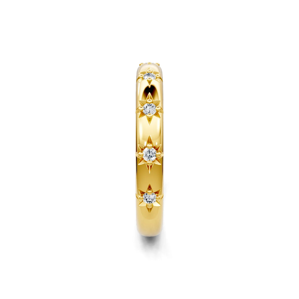 Gold ring with diamond accents on a white background