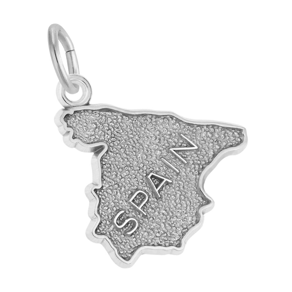 A silver charm shaped like the map of Spain, featuring a textured finish and the word 'SPAIN' engraved vertically on the front, shown on a white background