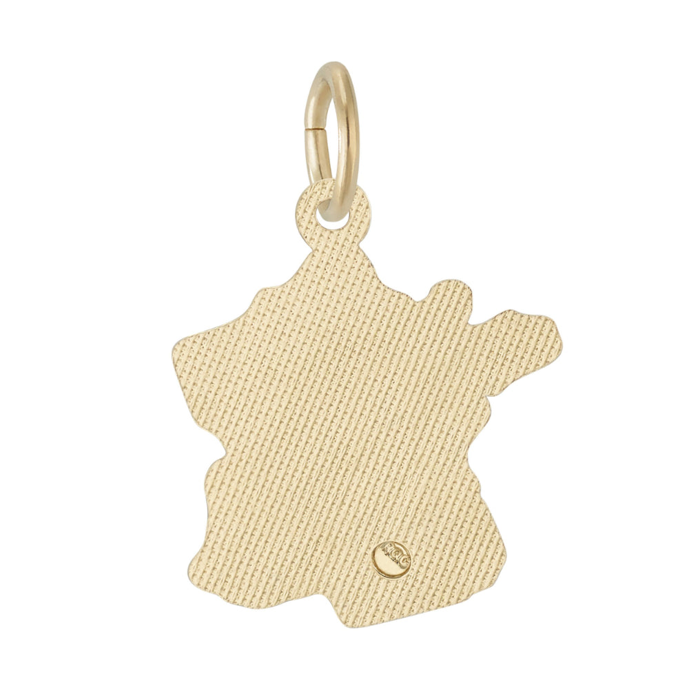 Textured back of a gold charm shaped like a map of France on a white background
