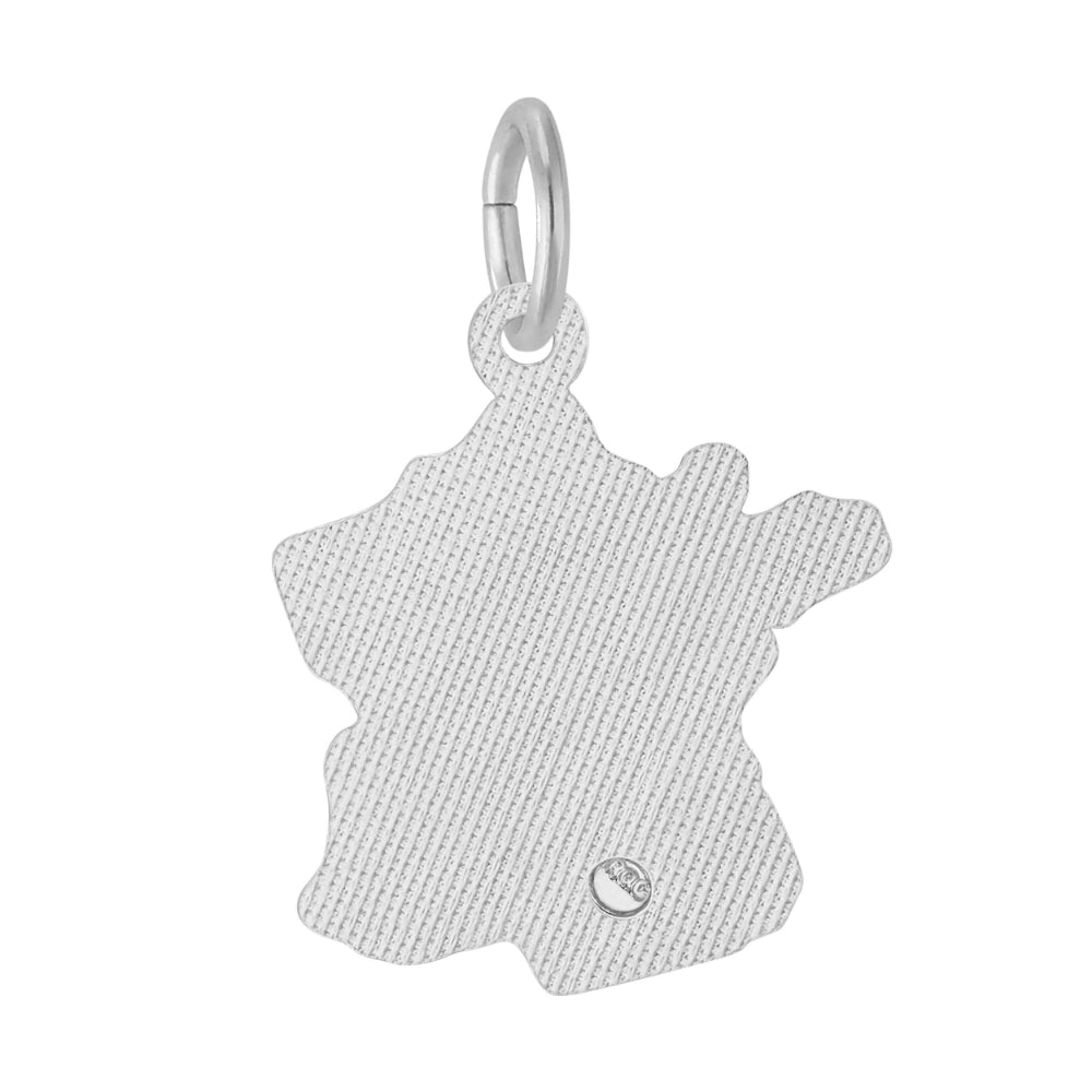 Textured back of a silver charm shaped like a map of France on a white background