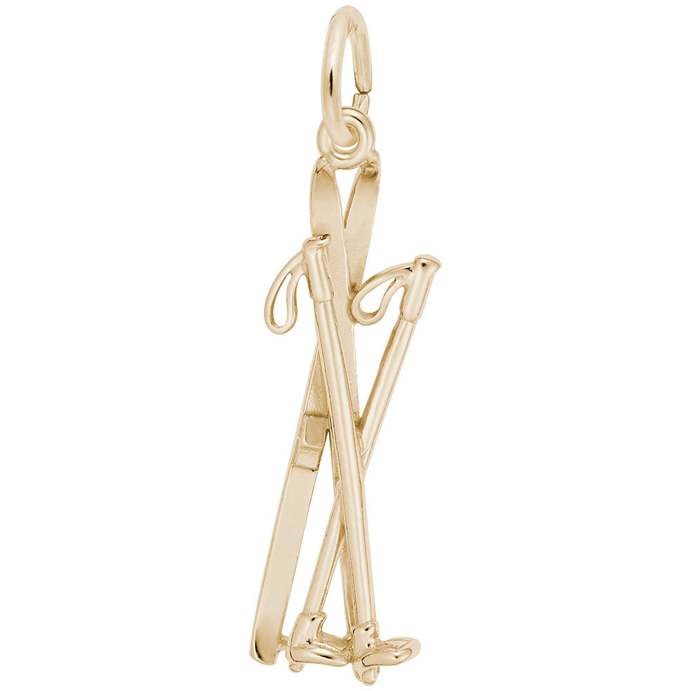 Gold crossed skis and ski poles charm on a white background