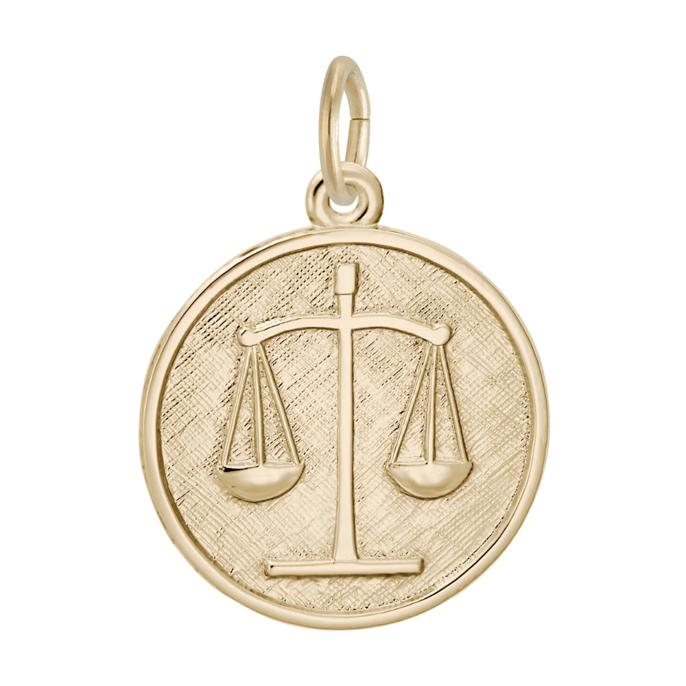 Gold disc charm with the scales of justice inscribed upon it, shown on a white background