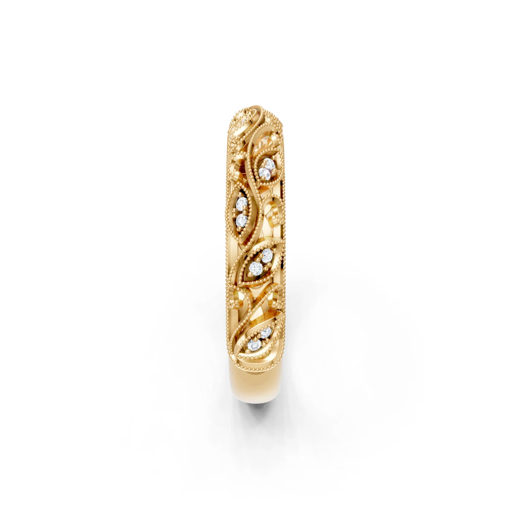 Gold ring with intricate design on a white background