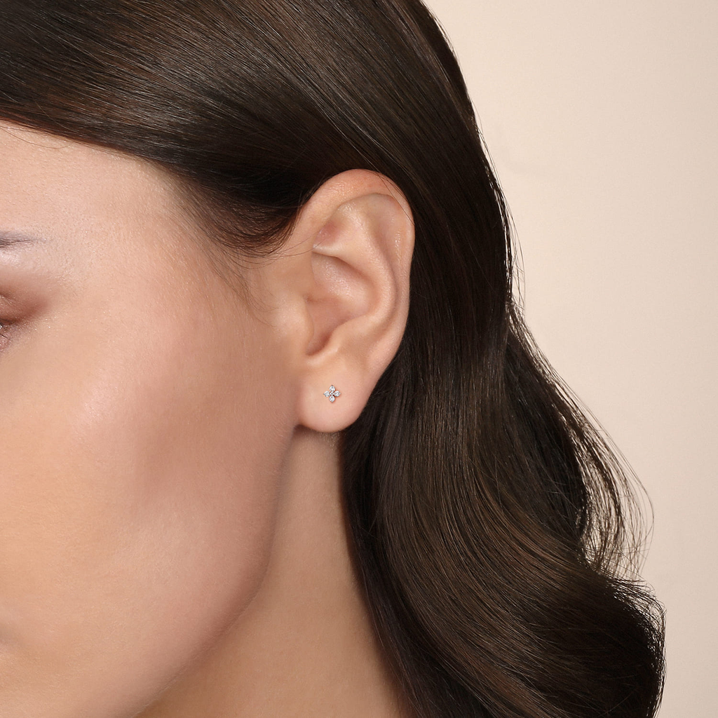 girl wearing clear stone stud earrings on natural background