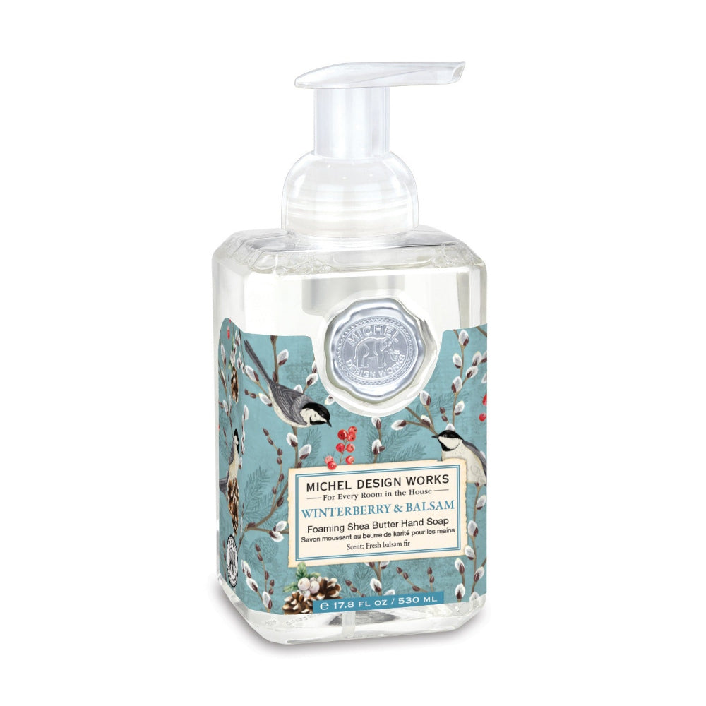 Hand soap bottle with decorative label featuring birds and winterberries on a white background.