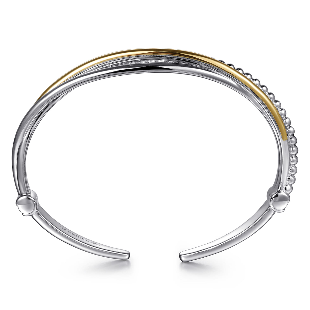 Bangle with gold and silver finish on a white background
