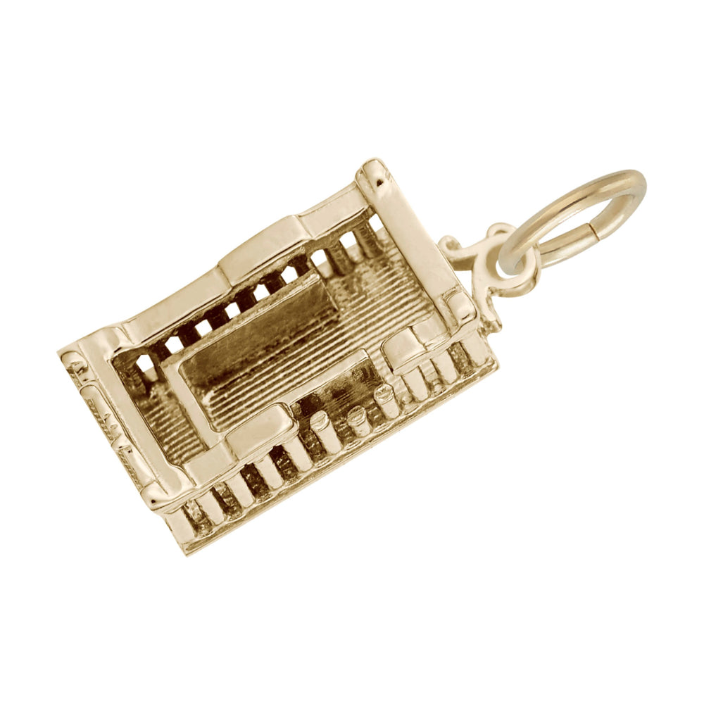 Top down view of a gold Parthenon shaped charm with textured floor, shown on a white background