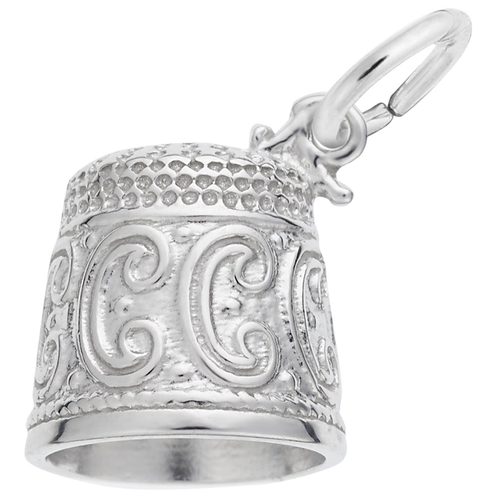 Silver thimble charm with intricate designs on a white background