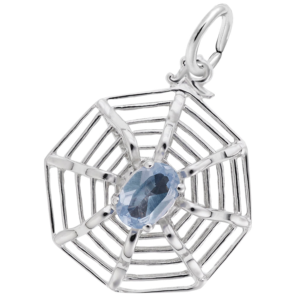 Silver spider web shaped charm with a blue gemstone on a white background