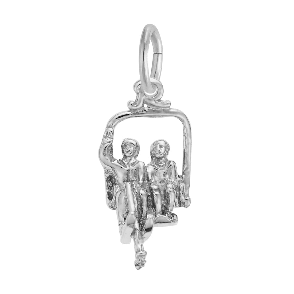 Silver charm of two people on a ski lift on a white background
