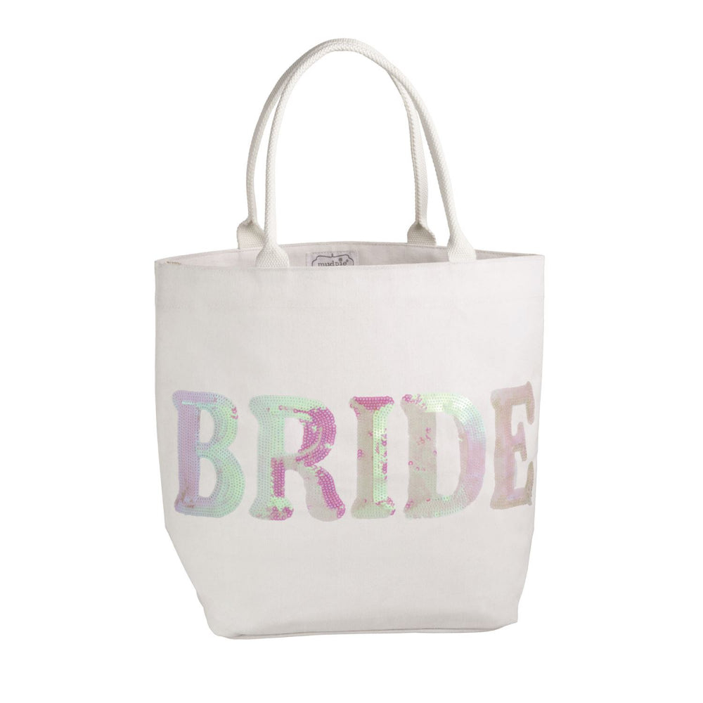 A white canvas tote bag with the word 'BRIDE' printed across the front in large, pastel tie-dye letters featuring shades of pink, purple, and mint green. The bag has two white shoulder straps and is photographed against a seamless white background.