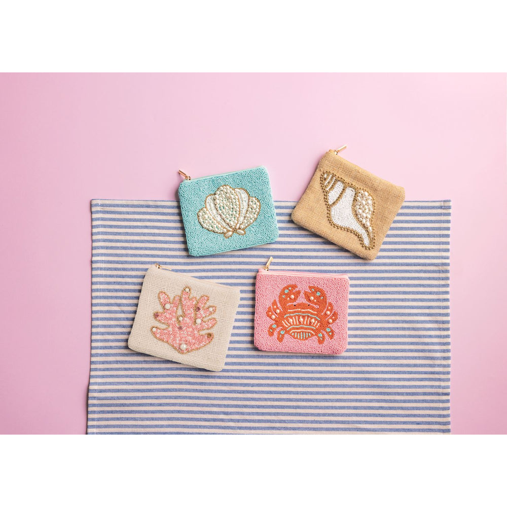 Four small pouches with shell designs on a striped fabric background