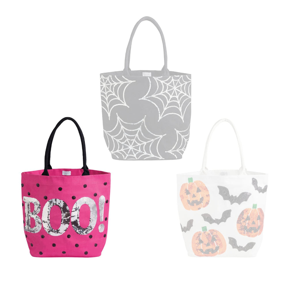 Pink halloween-themed tote bag with silver "BOO" text and black dots a white background.