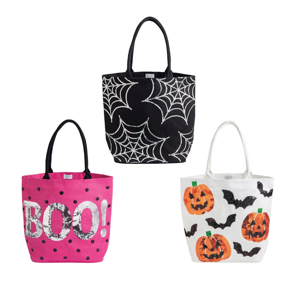 Three halloween-themed tote bags on a white background