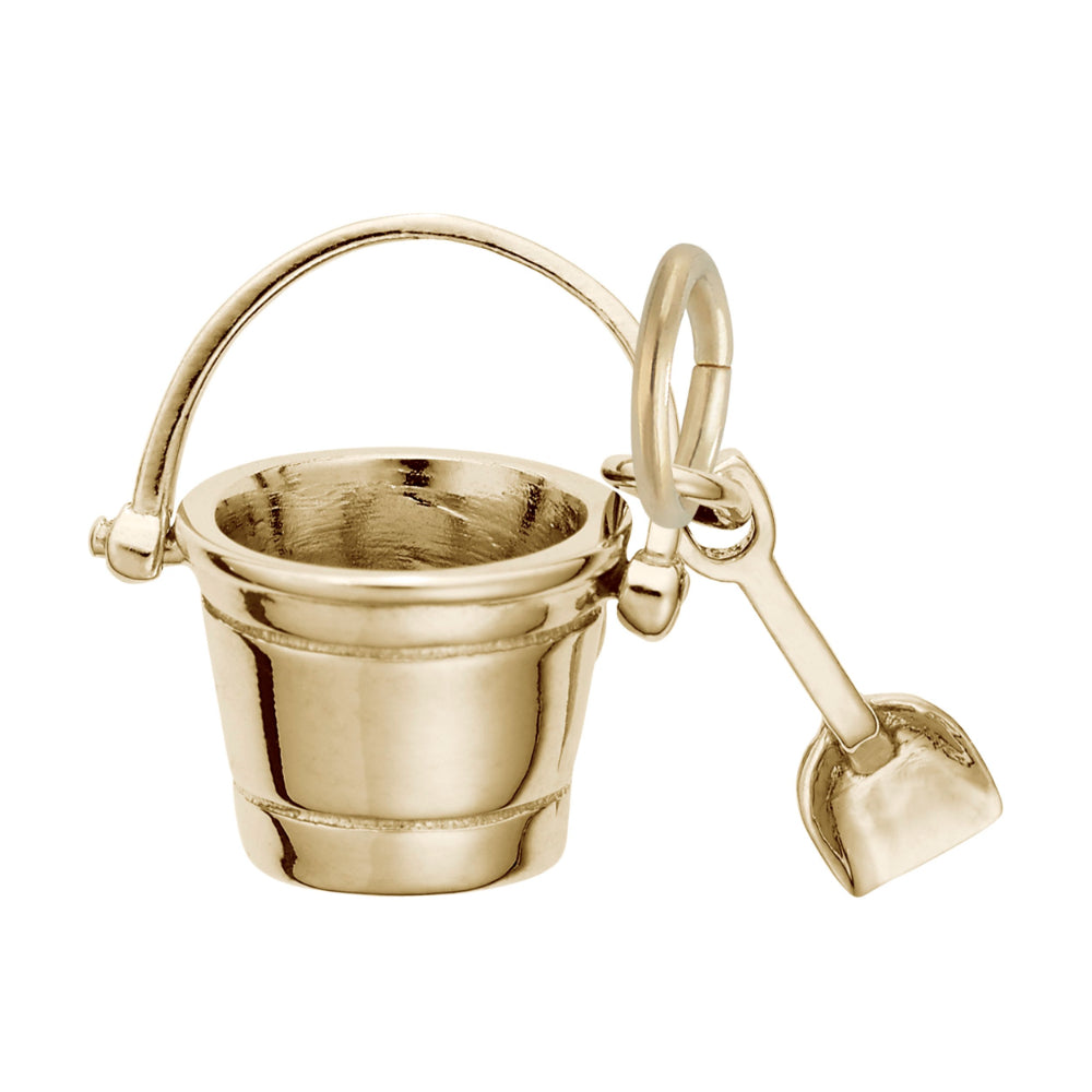 Gold bucket and shovel charm on a white background
