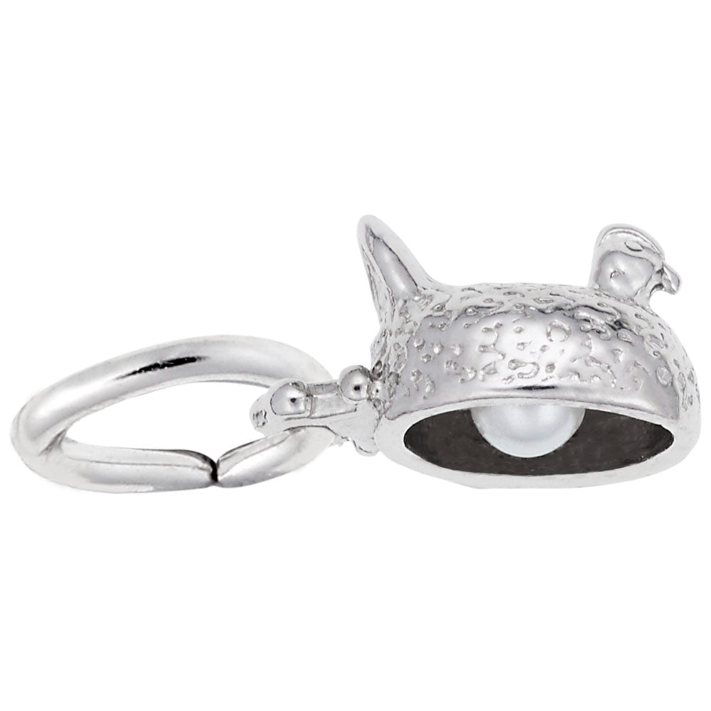 Bottom of a silver sitting chicken charm showing a white pearl egg, shown on a white background