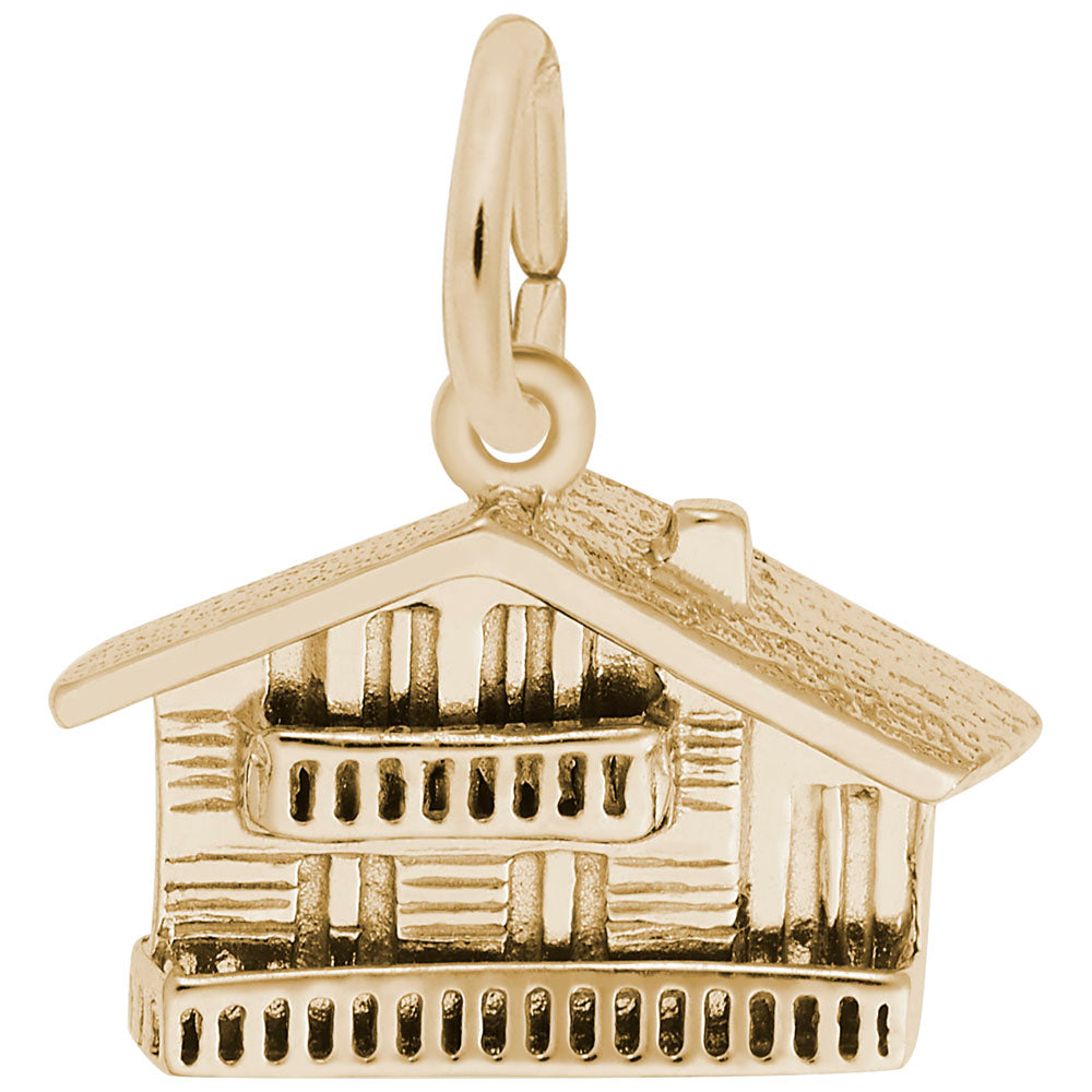 Gold Swiss Chalet shaped charm on a white background