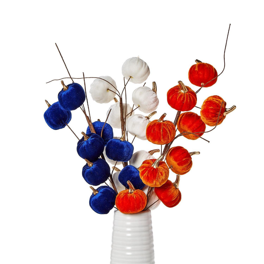Decorative arrangement of blue, white, and orange pumpkins in a white vase on a white background.