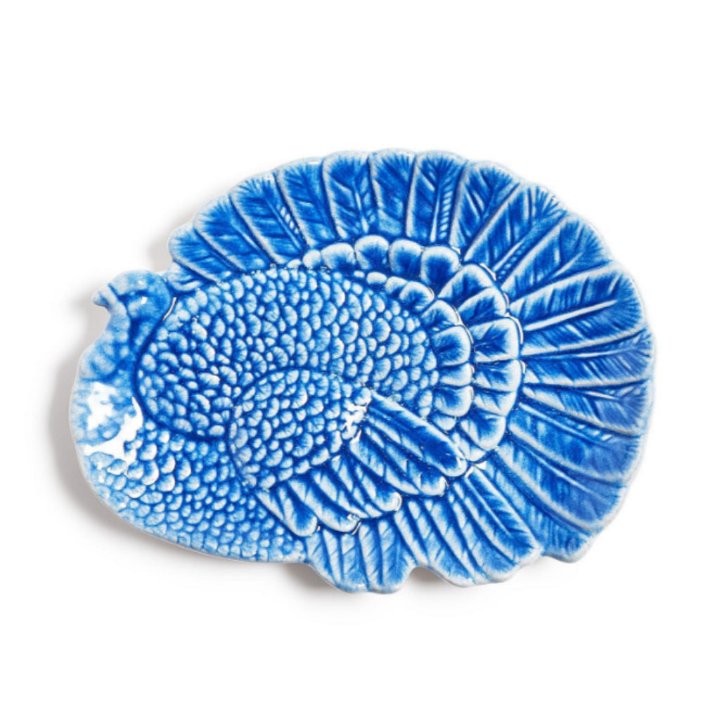 A blue and white ceramic serving platter shaped like a turkey, featuring a textured, raised design on a plain white background.