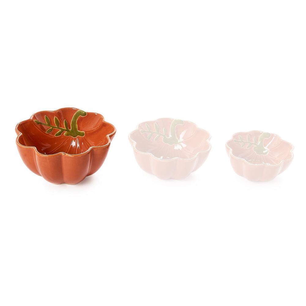 Large pumpkin-shaped ceramic bowl with scalloped edge in a terracotta orange color with green leaf design inside and gold trim on a white backround.