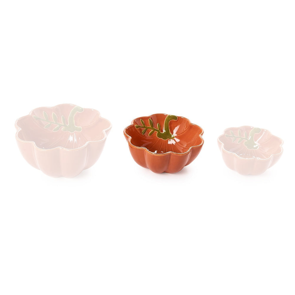 Medium pumpkin-shaped ceramic bowl with scalloped edge  in a terracotta orange color with green leaf design inside and gold trim on a white backround.