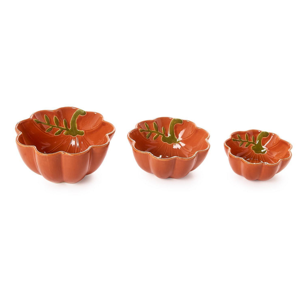 Three pumpkin-shaped ceramic bowls with scalloped edge in a terracotta orange color with green leaf design inside and gold trim, arranged by size on a white background.