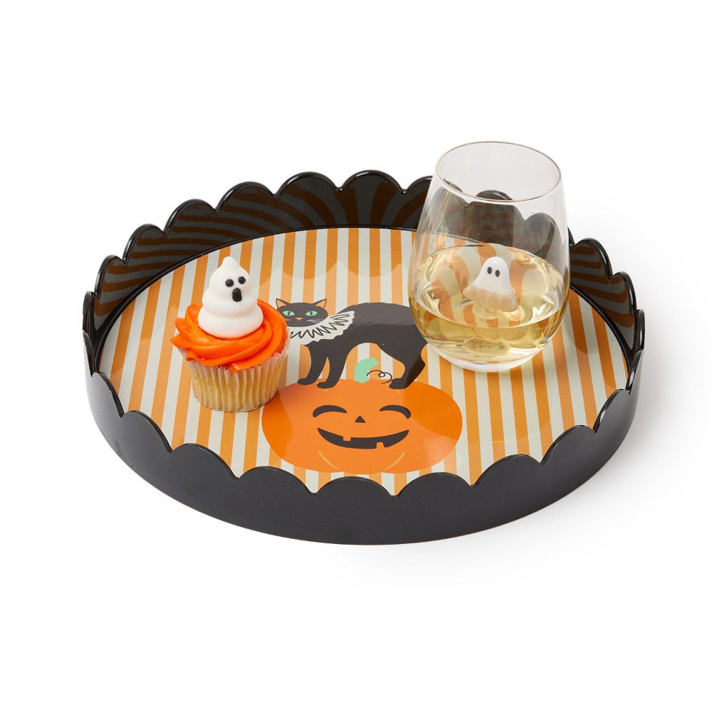 Halloween-themed tray with a glass of wine and a cupcake on a white background.