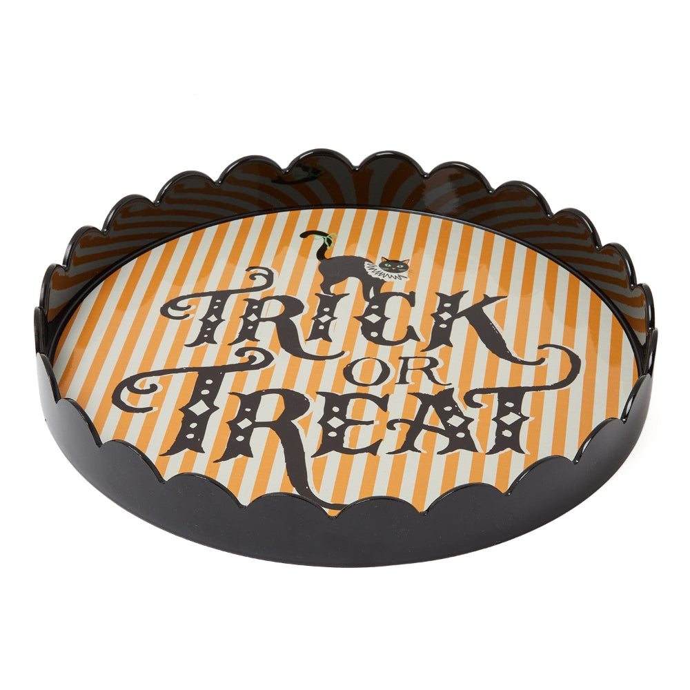 A scalloped Halloween-themed tray with a black rim and a printed center featuring orange and white vertical stripes, a small black cat silhouette, and the words 'Trick or Treat' in large black decorative lettering.