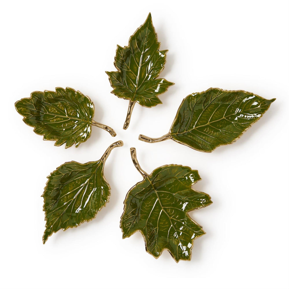 Set of five green leaf-shaped ceramic plates on a white background